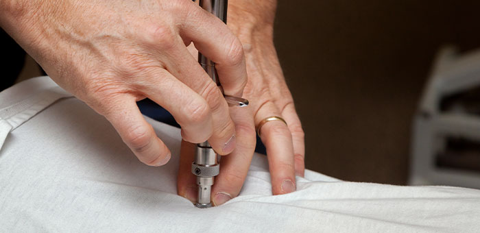 patient receiving activator methods technique in Irvine for auto accident injury